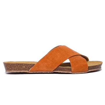 An orange suede sandal with crossed straps and a cork sole, handmade in Spain.